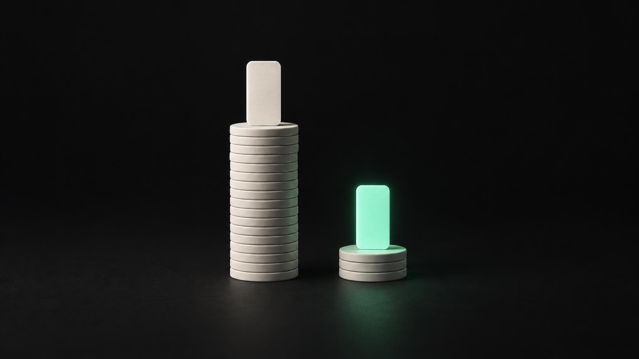 A tall stack of coins and a short stack of coins, each topped by the same phone-shaped card. The card on the short stack glows green.